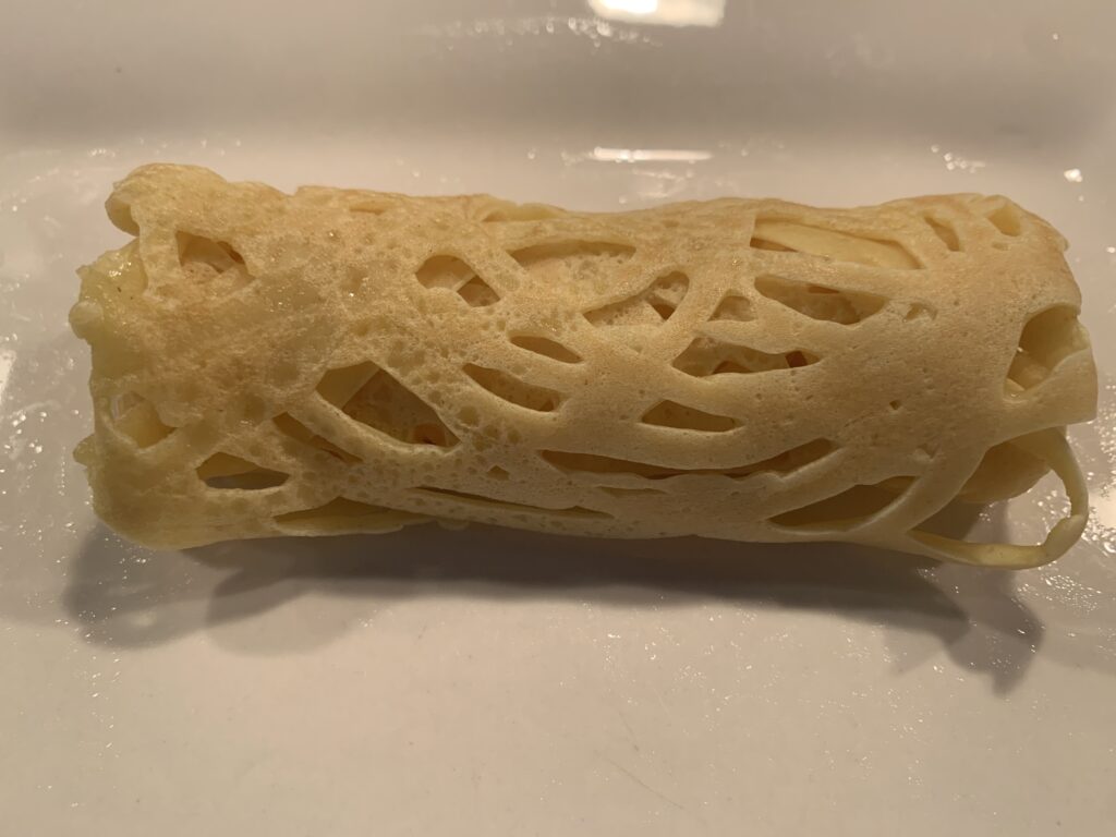Tasty Malaysian Roti Jala Roti Jala folded into a log shape