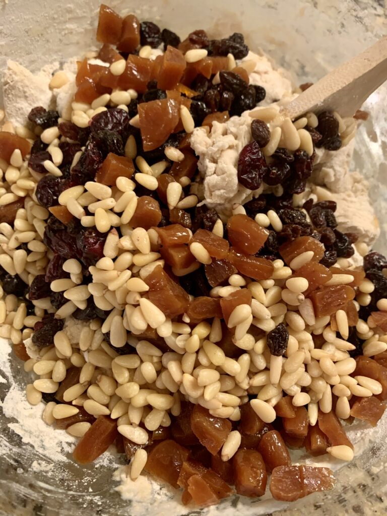 Mixing dried fruits and nuts to flour