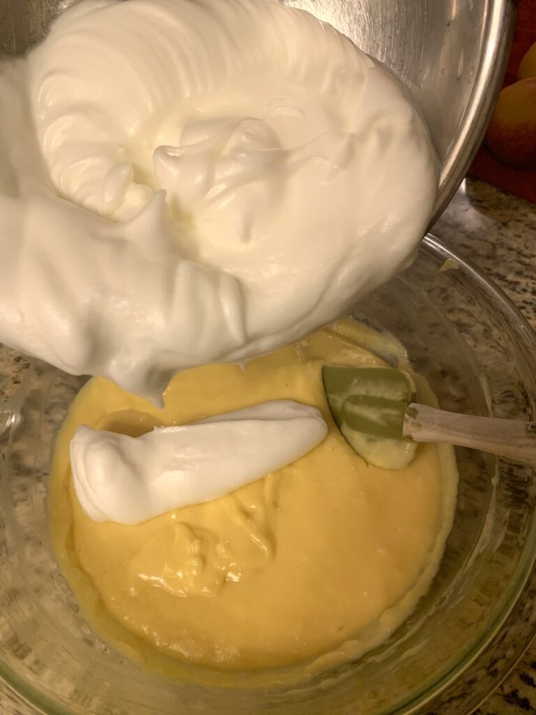 folding egg whites into the cheese egg yolk mixture