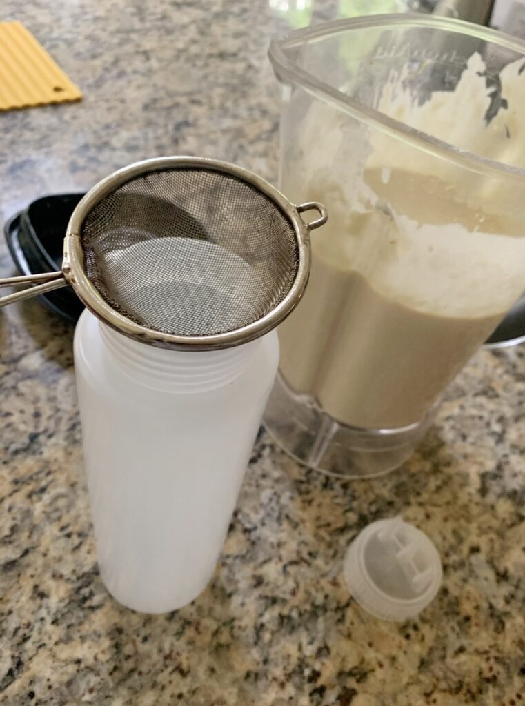 Pouring Roti Jala batter into the bottle