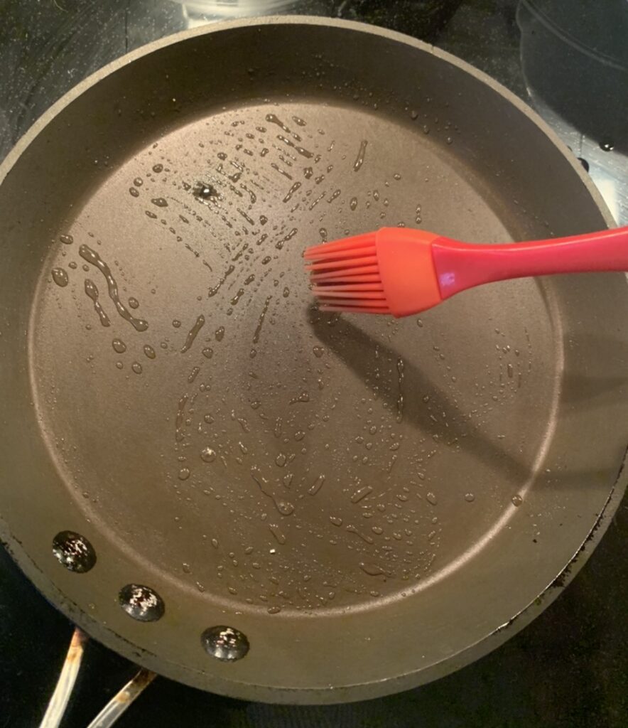 Brushing the pan with oil