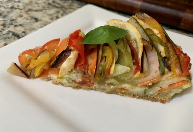 A slice of Coloful and Happy Veggie Blossom Tart