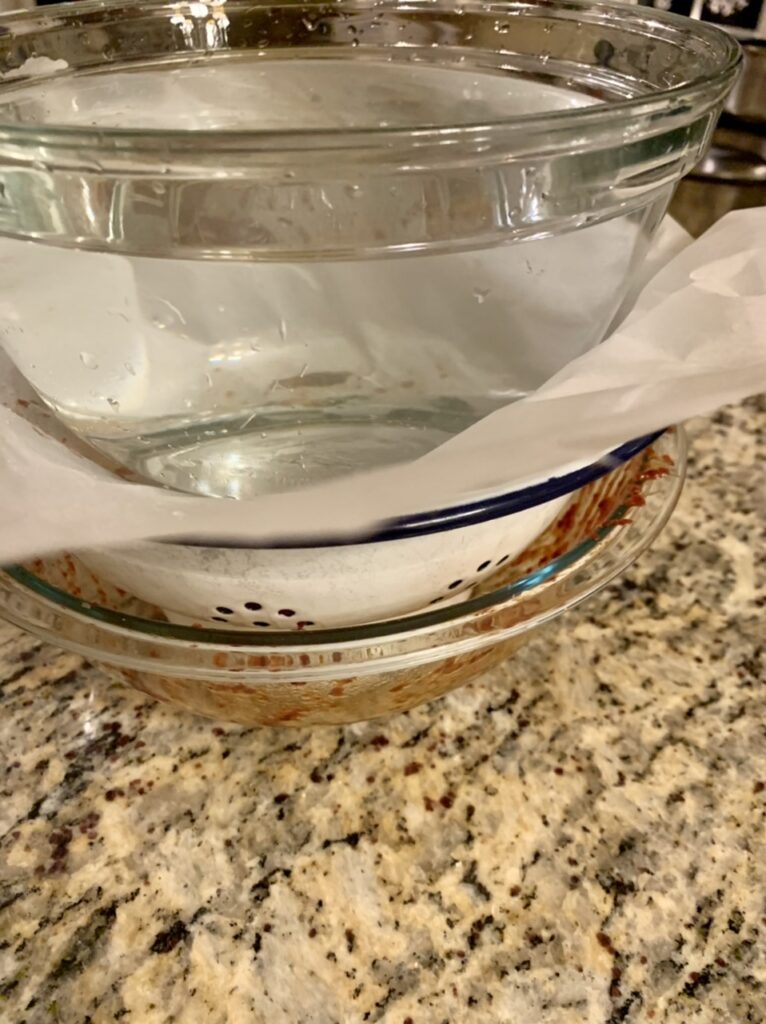 Place weigh on top of parchment paper covering the seasoned cucumber slices