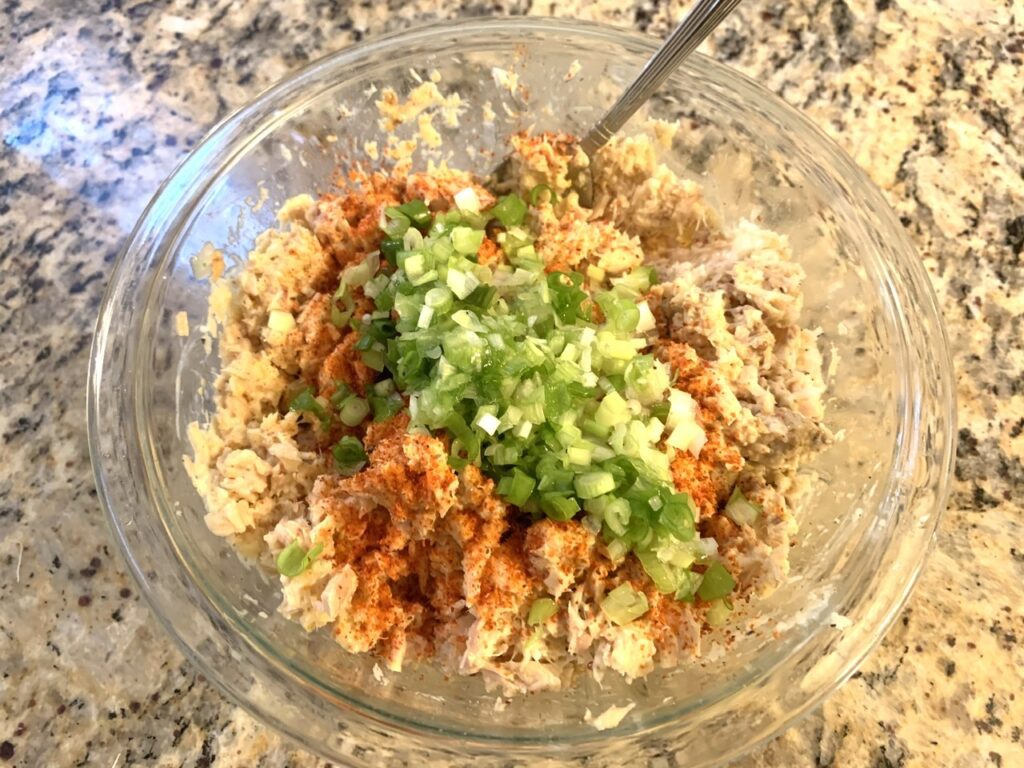 Mixing to combine ingredients for quick tuna patty cakes