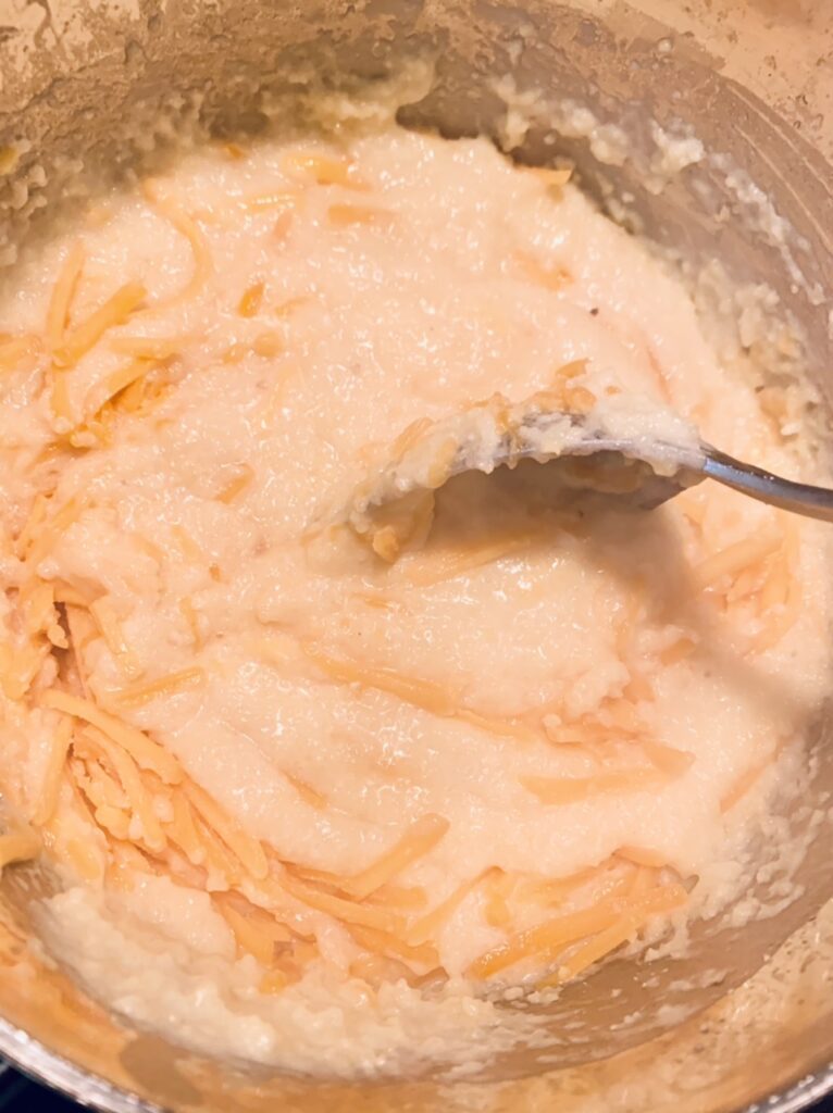 Stir in the shredded cheddar cheese for Scrumptious and Easy Shrimp and Grits