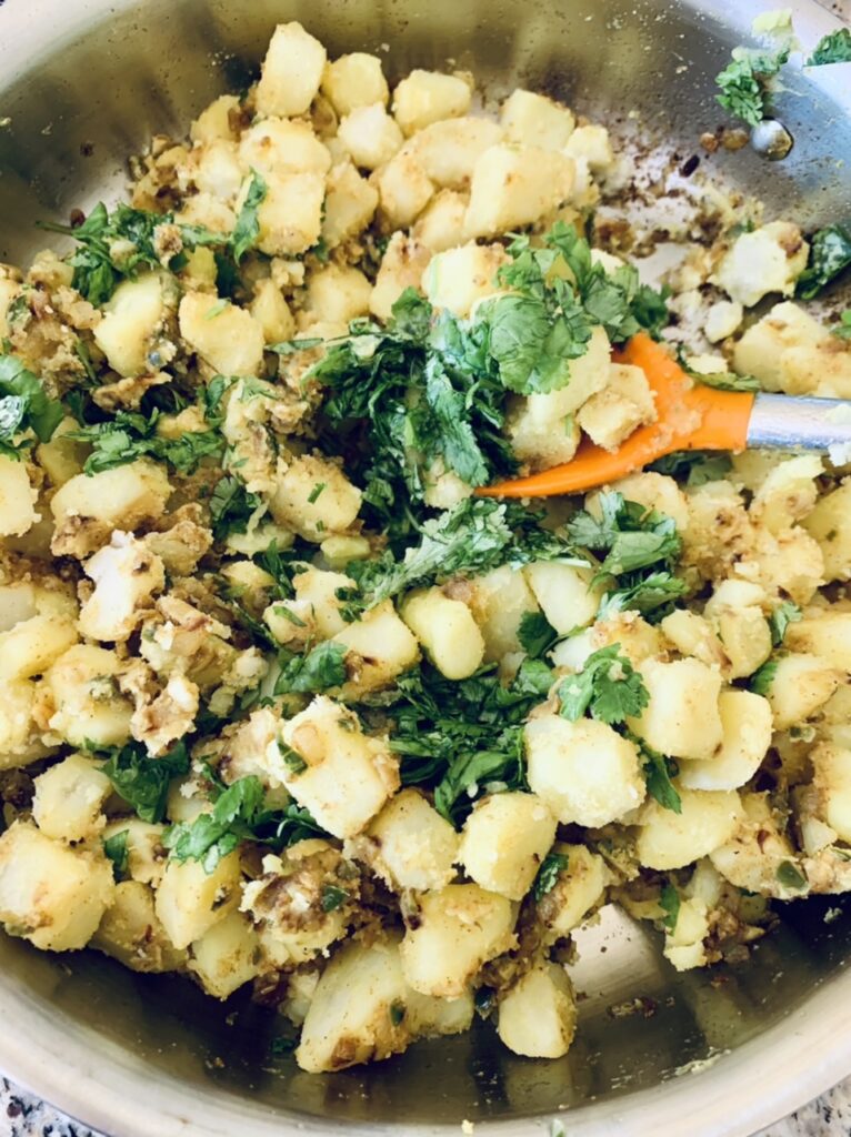 Preparing filling for Spicy Potato Samosas